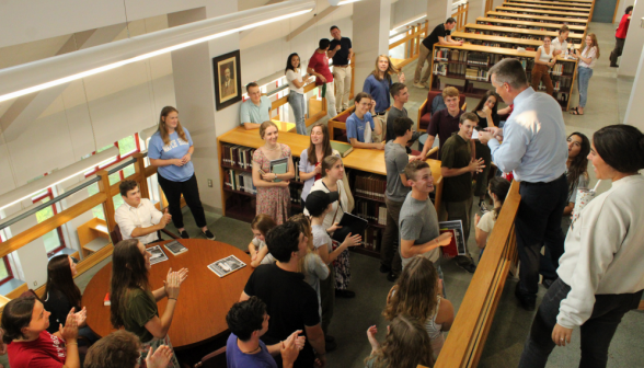 Students applaud as Jon Daly completes roll call the fastest