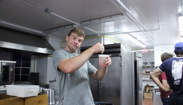 David Carey, prefect, sticks a straw in soda while making a wry face