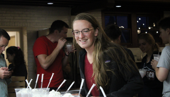 Irene Collins, prefect, looks over a row of sodas