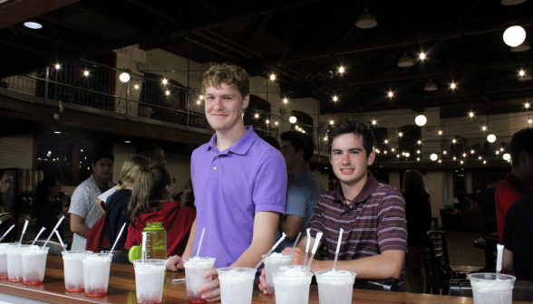 Two students at the counter. One takes a soda, one already has one