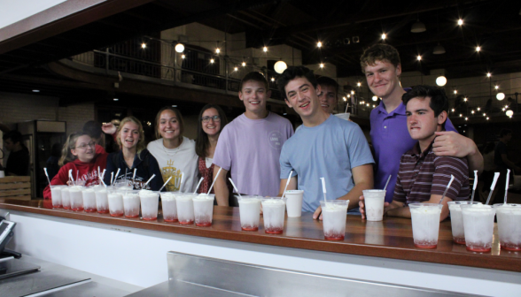A row of students at the counter, afront the row of Italian sodas