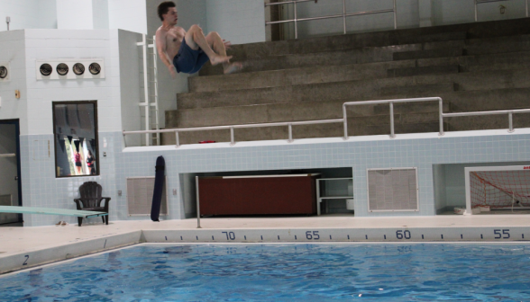 A prefect in midair, having jumped off the diving board