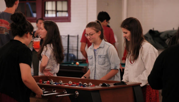Students play a doubles game of foosball