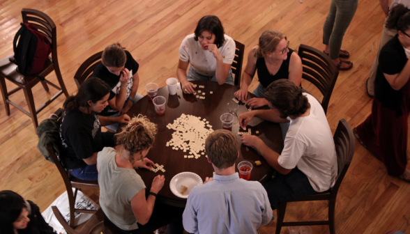 A seven-person game of Bananagrams gets underway