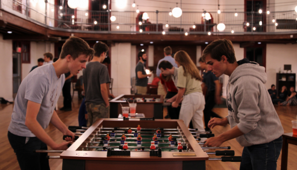 An intense 1v1 foosball showdown, scores nearly equal