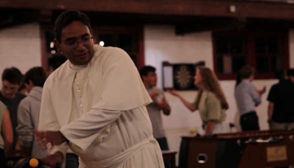 Ping-pong: Father Miguel winds up for a forehand
