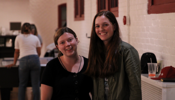 Cecilia Huckins, photographer, with a student, smiling for the camera