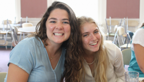 Meg Murphy, prefect, smiles for a photo with a student