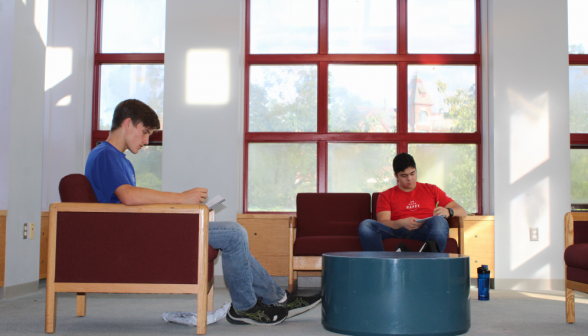 Two students in armchair and couch in the music room