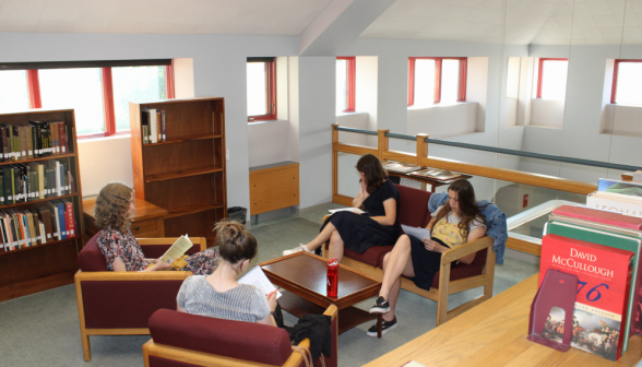 Four study around a small table on the library's upper area