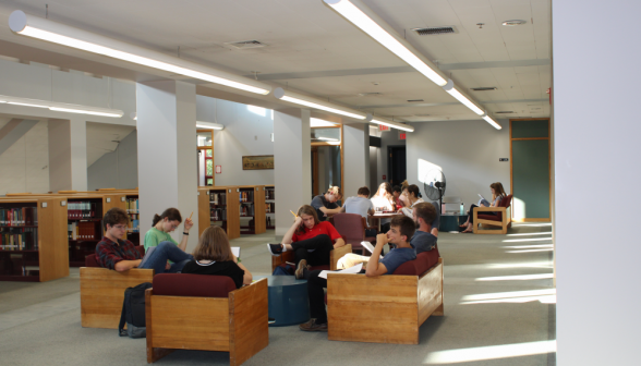 The main area of the library, filled with students bent over their books