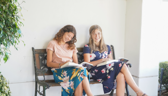 Students on bench outside library