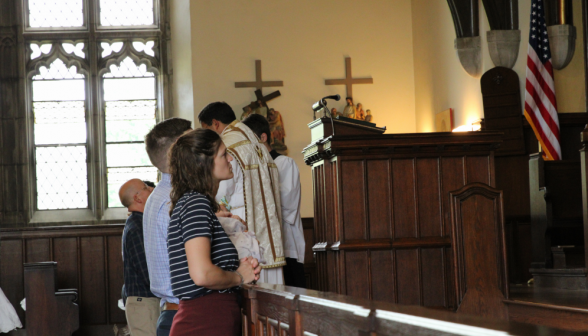 TAC families kneeling at the Communion railing