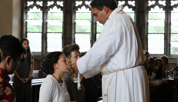 A student kisses the relic