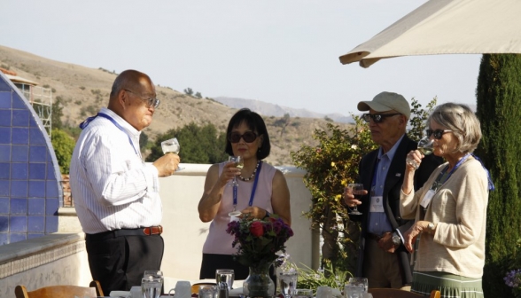 Attendees chat before sitting down to a meal