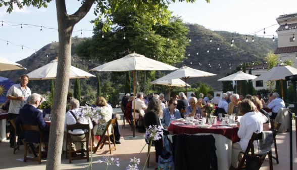 Long shot of the tables, filled, set up on Gladys Patio