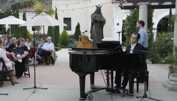 Longer shot of both singer and piano accompanist