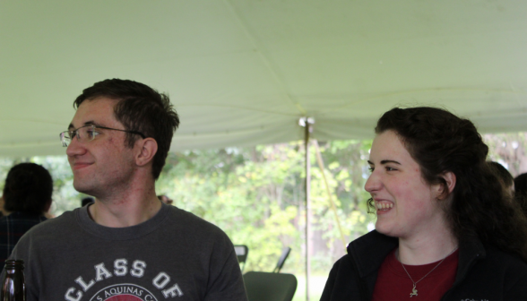 Two students laugh at something out of frame to the left