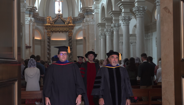 The tutors pass through the Chapel doors