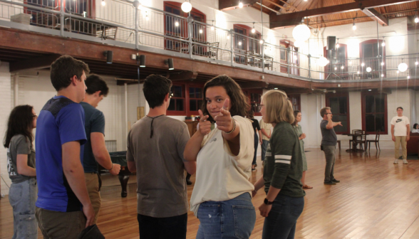 A student gives "finger guns" to the camera