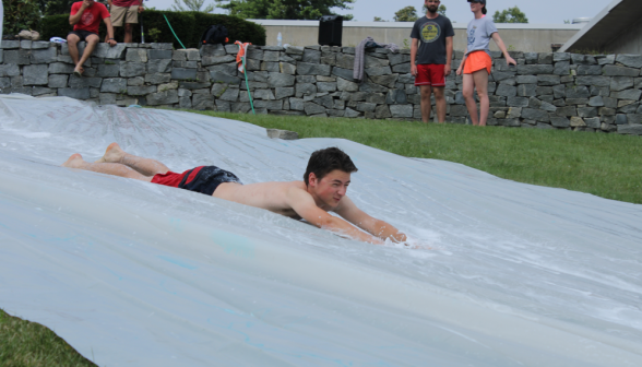 A student goes down the slide