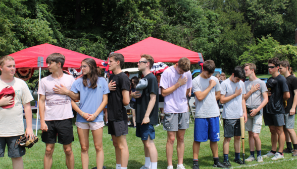 Students place their hands over their hearts for the Pledge of Allegiance