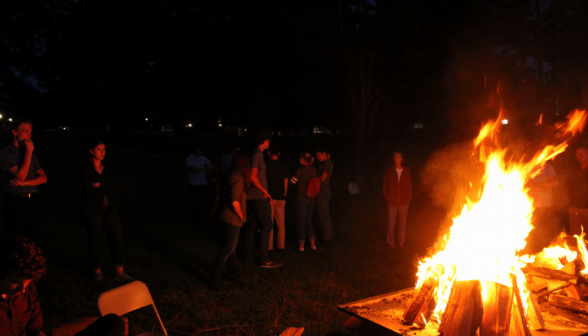 The bonfire, with a few students partly visible behind it