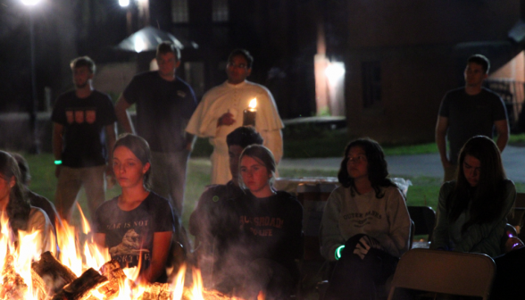 Another view of some students and Fr. Miguel looking into the fire pensively