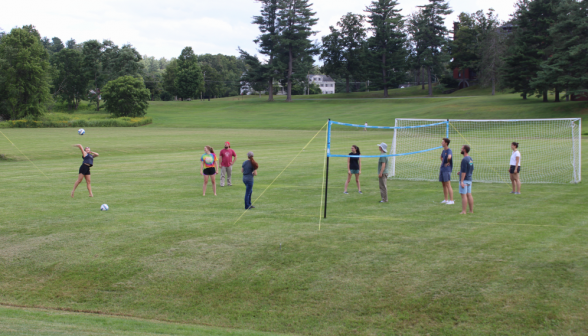 A game of volleyball, with the serve in action