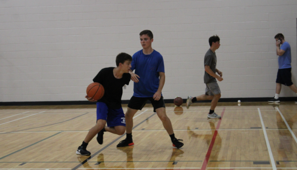 Basketball game: A student attempts to capture the ball from another