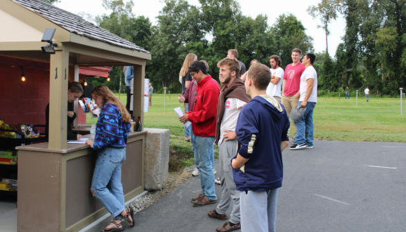 Students and prefects line up to place orders at the snack shop counter