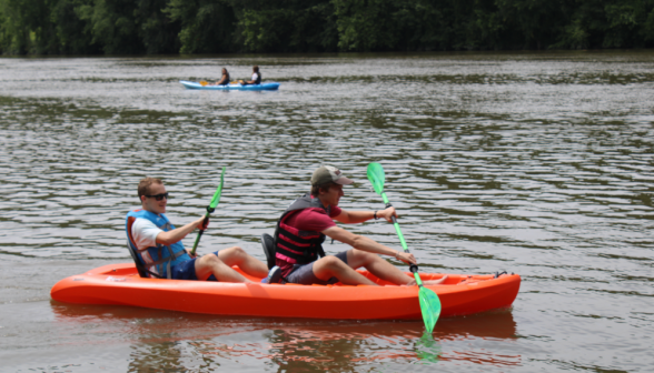 Two students in life vests kayaking