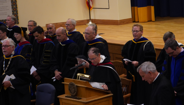 Fr. Paul speaks at the podium