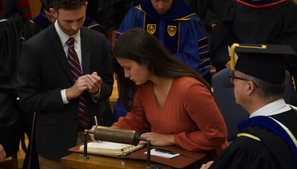 A student signs the register
