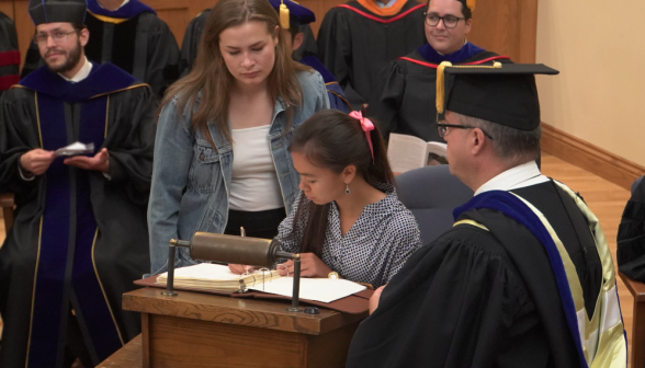 A student signing the register