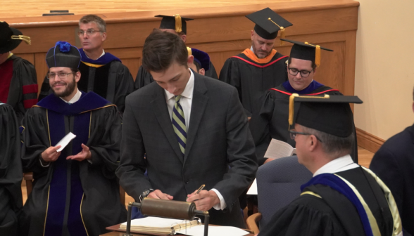 Another student signs the register