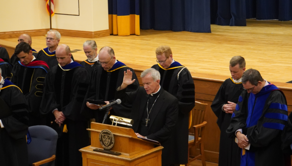 His Excellency leads the assembly in prayer