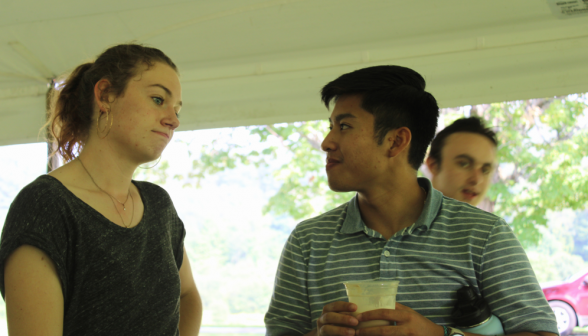 Two students chat over their floats