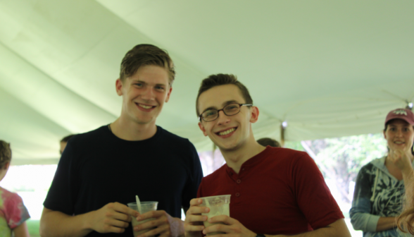 Two students pose with their floats