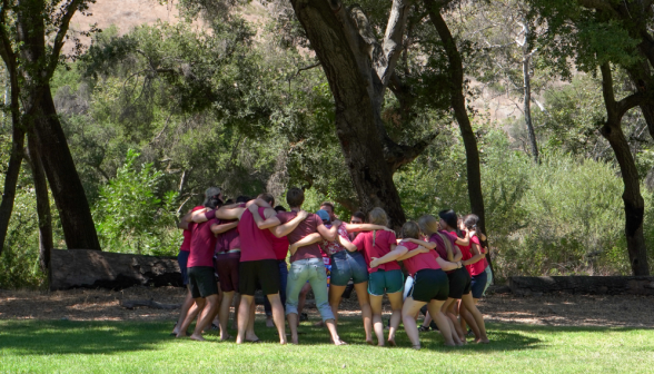 A student team group hugs