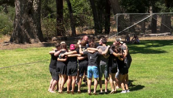 Another team of students does a group hug