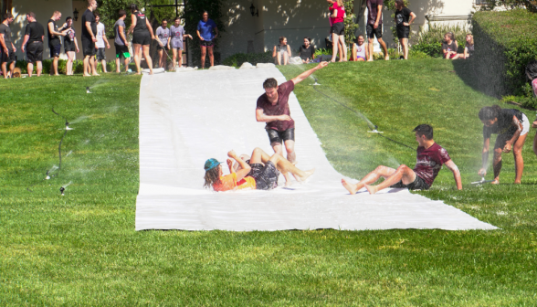 Students speed down a waterslide