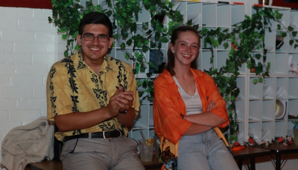 Two students smile at the camera near the mailboxes