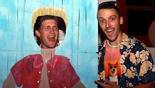 A student poses in a "See yourself as a Californian" display, while another poses alongside