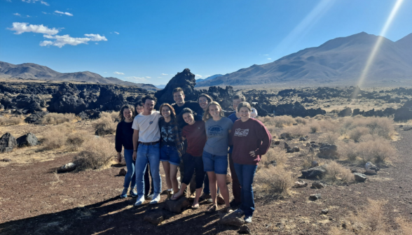 A group of students pose amid the rockscape