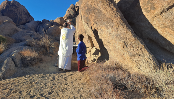 Fr. Paul offering Mass on a portable altar, elevates the Host