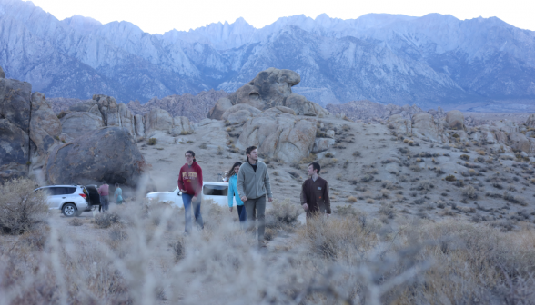 Students emerge from the cars, surrounded by the wilderness