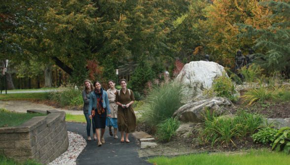 Four girls walk along one of the winding paths