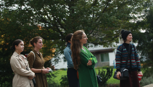 A group of students pause before one of the monuments