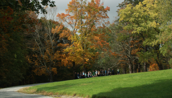 A distance shot of the students walking amidst the fall colors